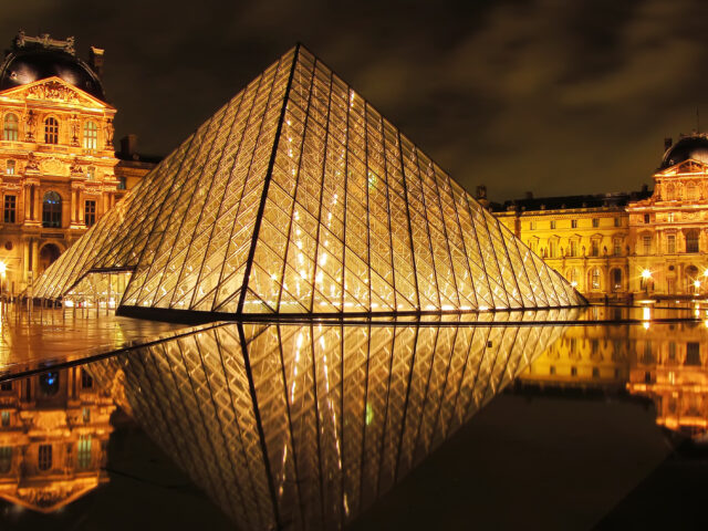 Louvre Museum at night, beautifully illuminated, symbolizing how even history’s most secure institutions must constantly safeguard what is priceless.